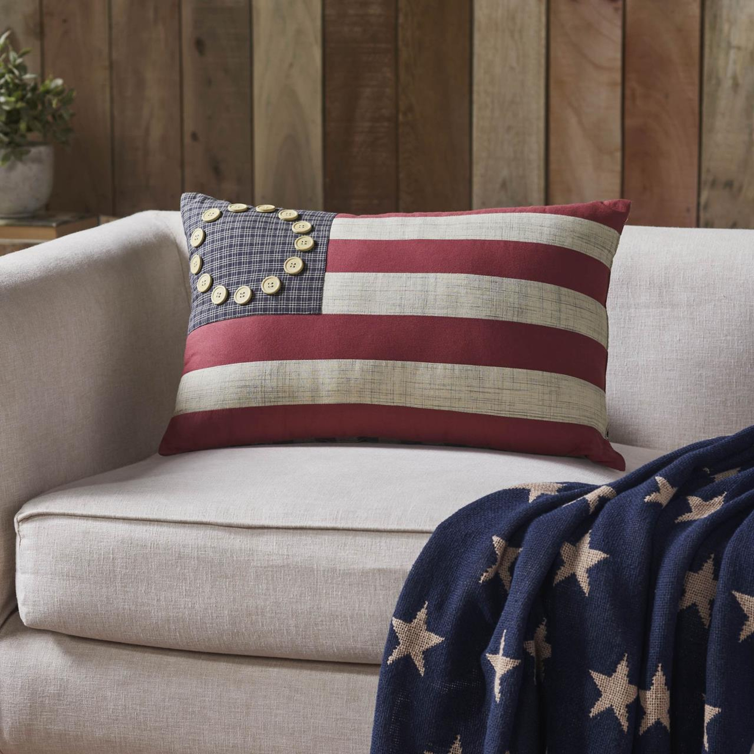 American flag throw pillow and blanket on a couch